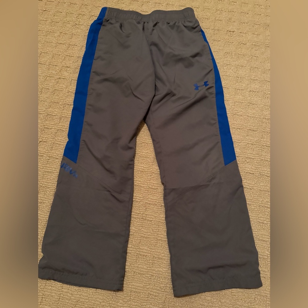 Under Armour athletic pants in gray with blue accents, size small w/ lining
